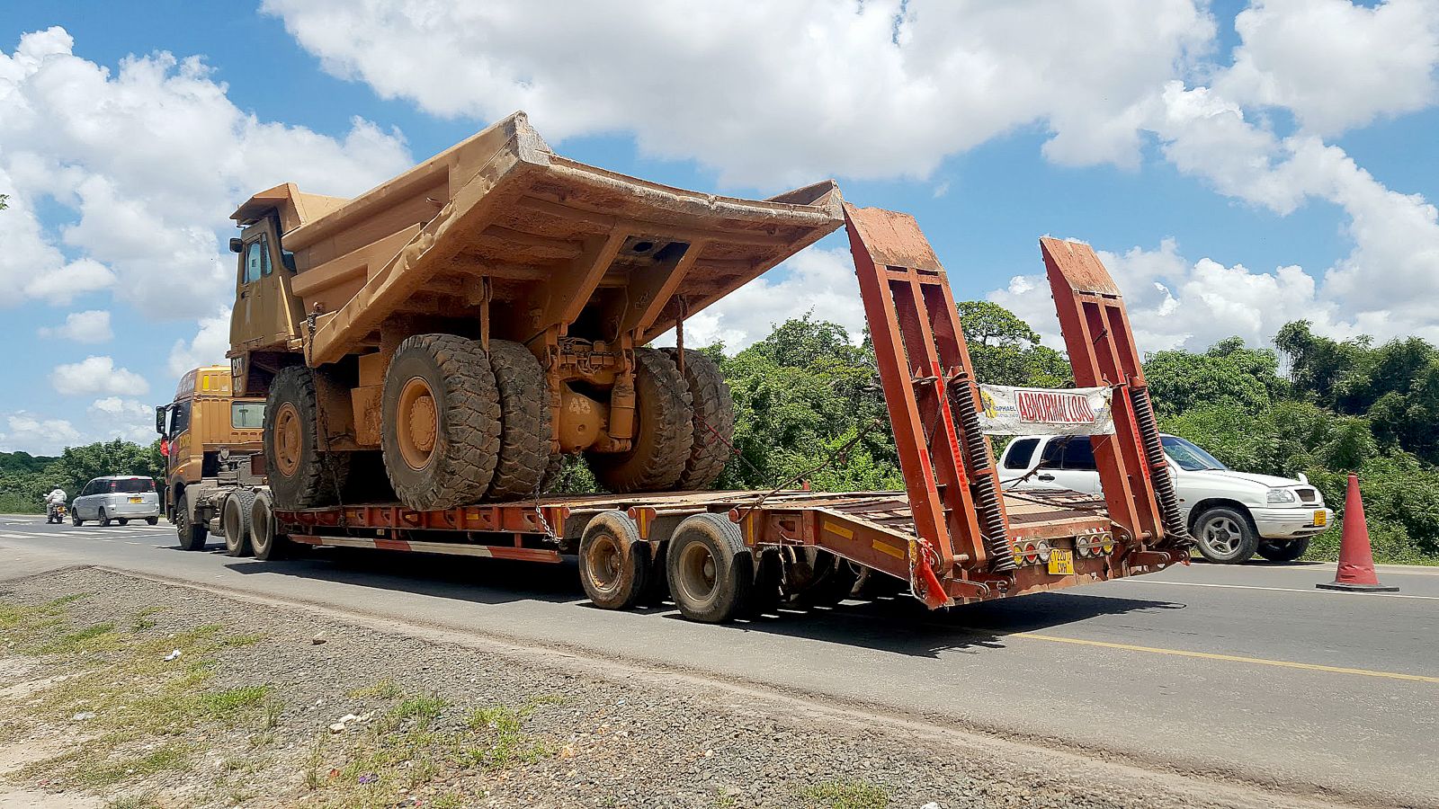 Oversized heavy equipment being transported on a flatbed trailer